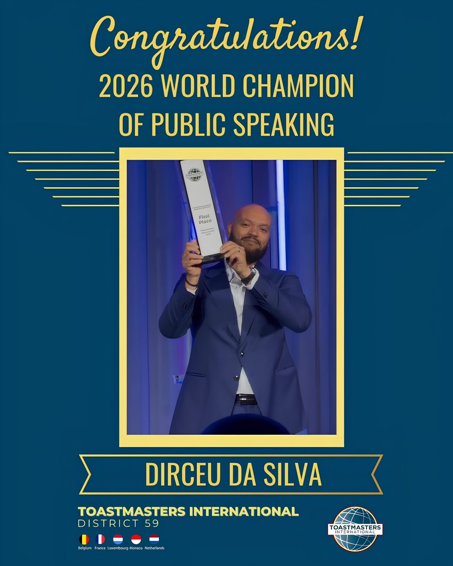 Dirceu Da Silva holding the 2026 World Champion of Public Speaking trophy, Toastmasters International District 59