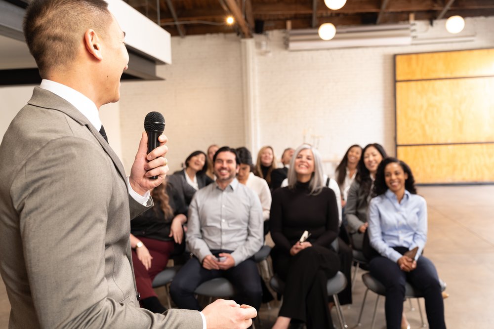 Toastmasters International speaker addressing an audience, general atmosphere